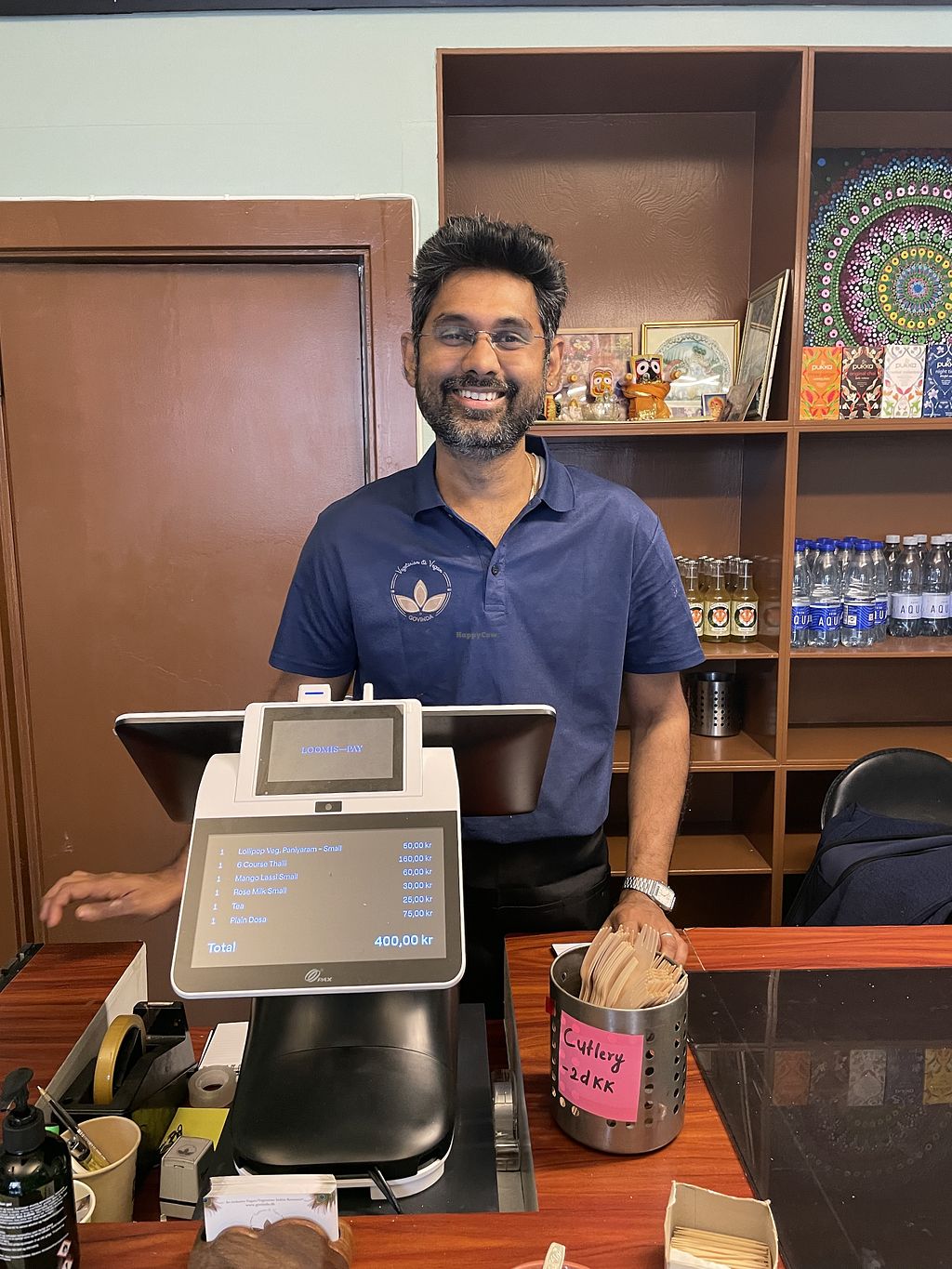 A member of the Govinda team at the counter