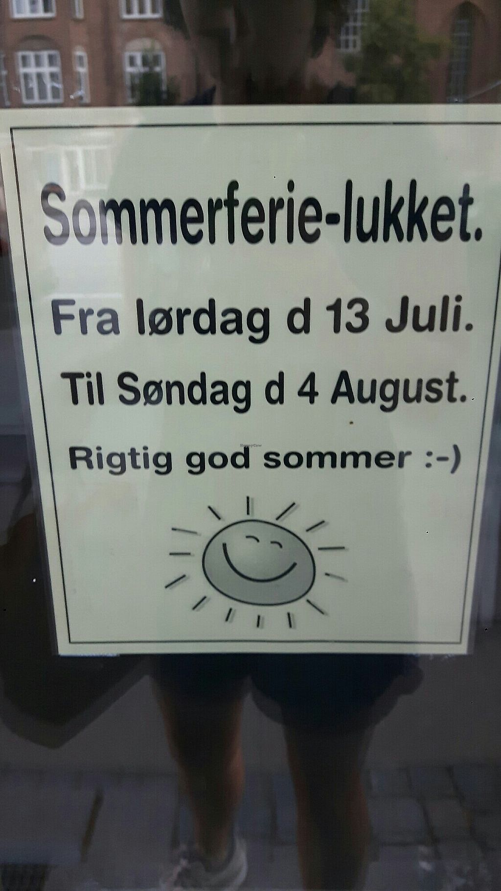 A sign in the window announcing the summer holiday closure