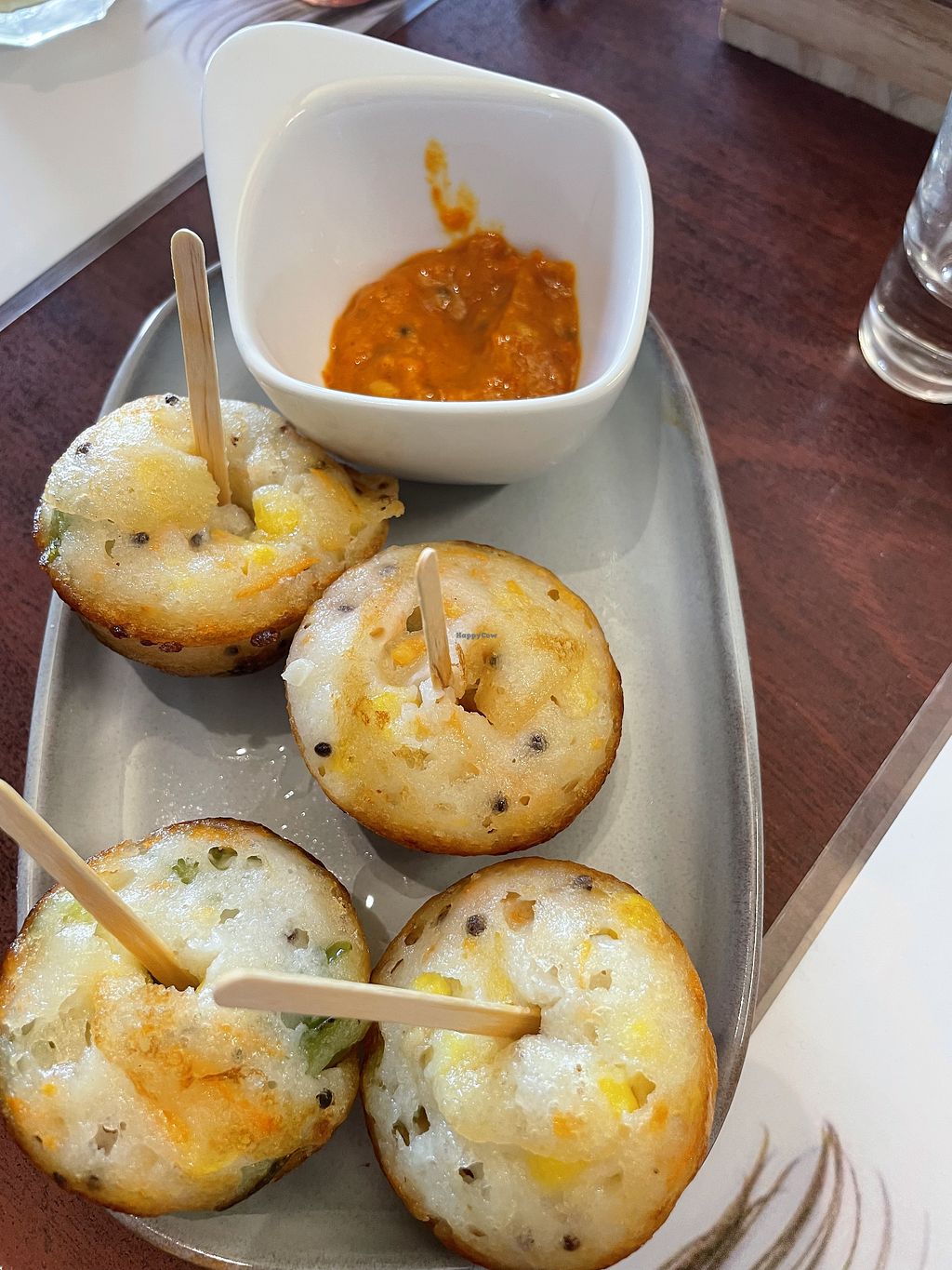 Steamed snacks served on skewers with chutney