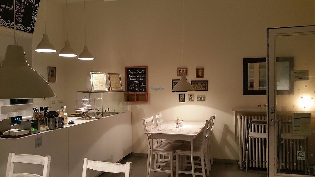 The Govinda dining room, with framed menus and seating ready before service