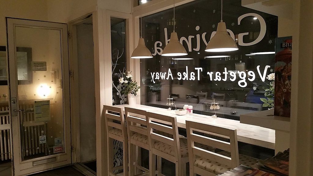 The Govinda takeaway window seen from inside, seating along the counter