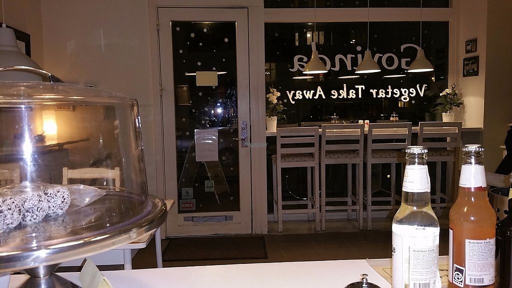 A cake stand and bottles on the counter